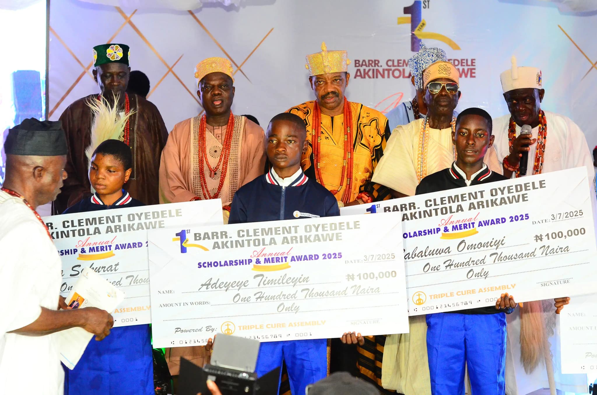 Scholarship award ceremony with students holding giant checks